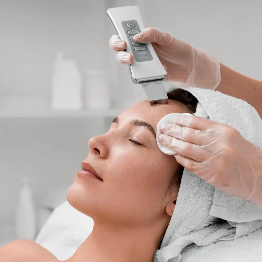 Aesthetician performing dermaplaning facial on client at Aesthetic Studio in St. Augustine, FL to exfoliate and smooth skin