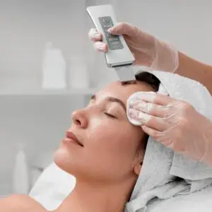 Aesthetician performing dermaplaning facial on client at Aesthetic Studio in St. Augustine, FL to exfoliate and smooth skin
