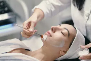 Young woman receiving chemical peel facial at Aesthetic Studio in St. Augustine, Florida