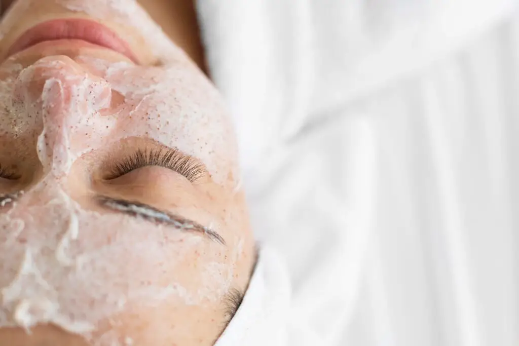 Woman receiving exfoliating signature facial mask at Aesthetic Studio in St. Augustine, FL