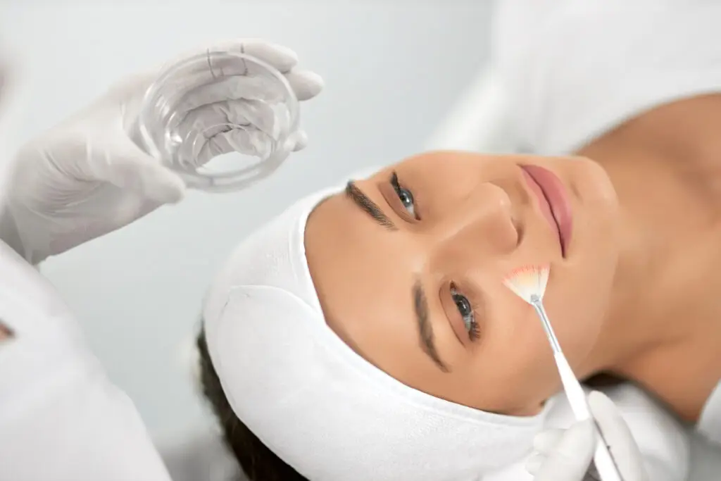 Senior woman receiving anti-aging chemical peel treatment at Aesthetic Studio in St. Augustine, FL